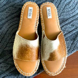 A pair of Myra boutique cowhide sandals.
